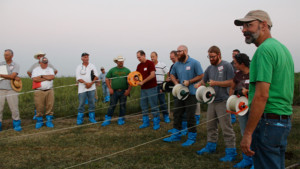 Dr. Matt Poore watches as participants race to see who can reel in their line of electric fencing the fastest. Electric fencing demonstrations are a major component of the Amazing Grazing workshops. Photo by Sarah Lyons