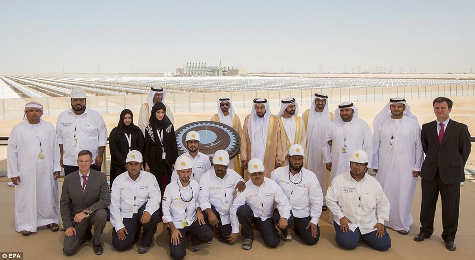 Proud: The men and women behind Shams 1 pose for a picture in front of the new plant